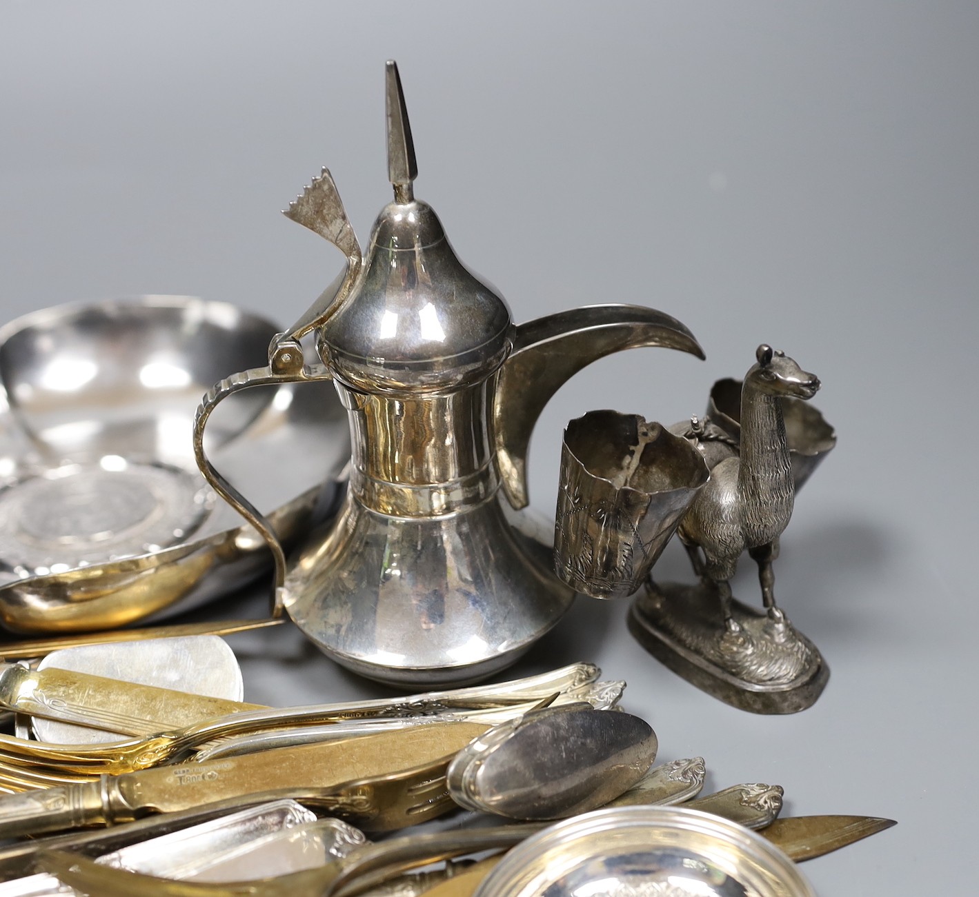 A Peruvian sterling dish with inset coin, an Egyptian white metal pill box, other 925 and white metal items including flatware, ring and sterling travelling beakers.